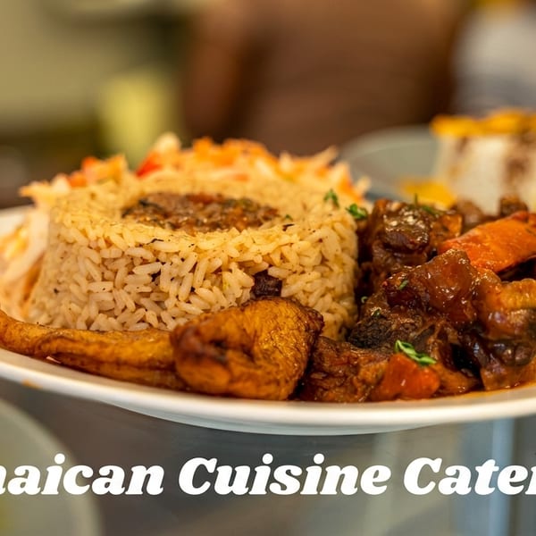 A plate of Jamaican cuisine with rice, stewed meat, and fried plantains.
